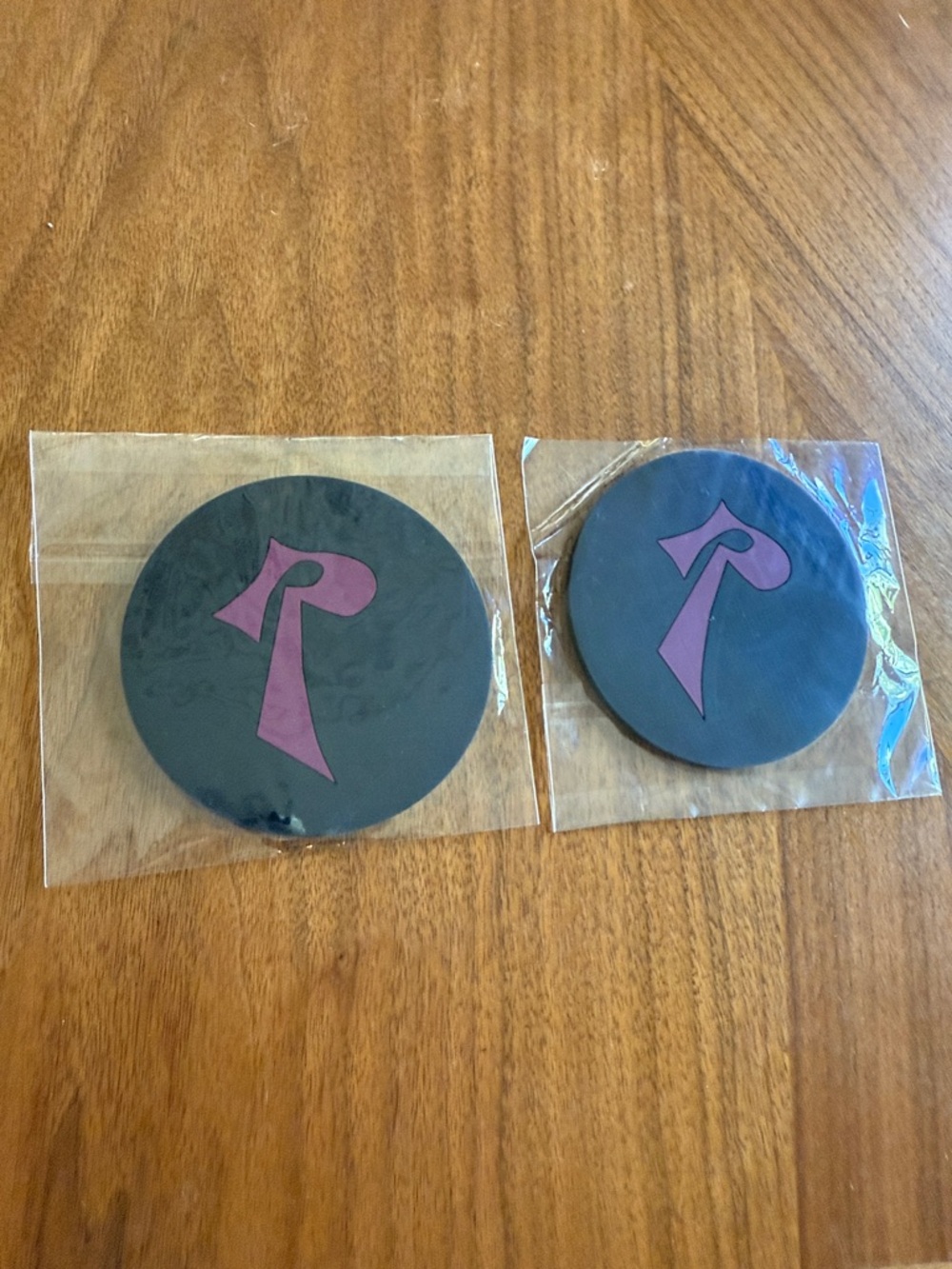 Set of 2 Black Round Coasters with burgundy Logo